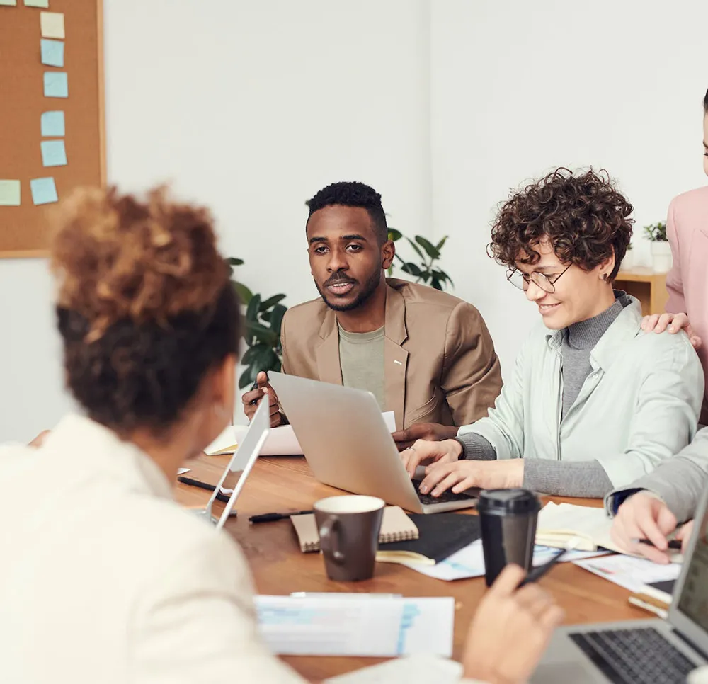 HR team reviewing employment verification details around a conference table