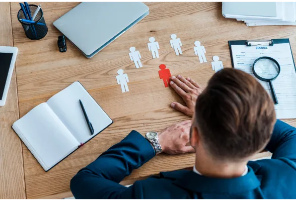 HR professionals reviewing hiring documents together in a bright modern office.