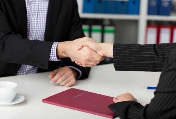 Diverse professional team collaborating in a bright modern office — safer hiring.